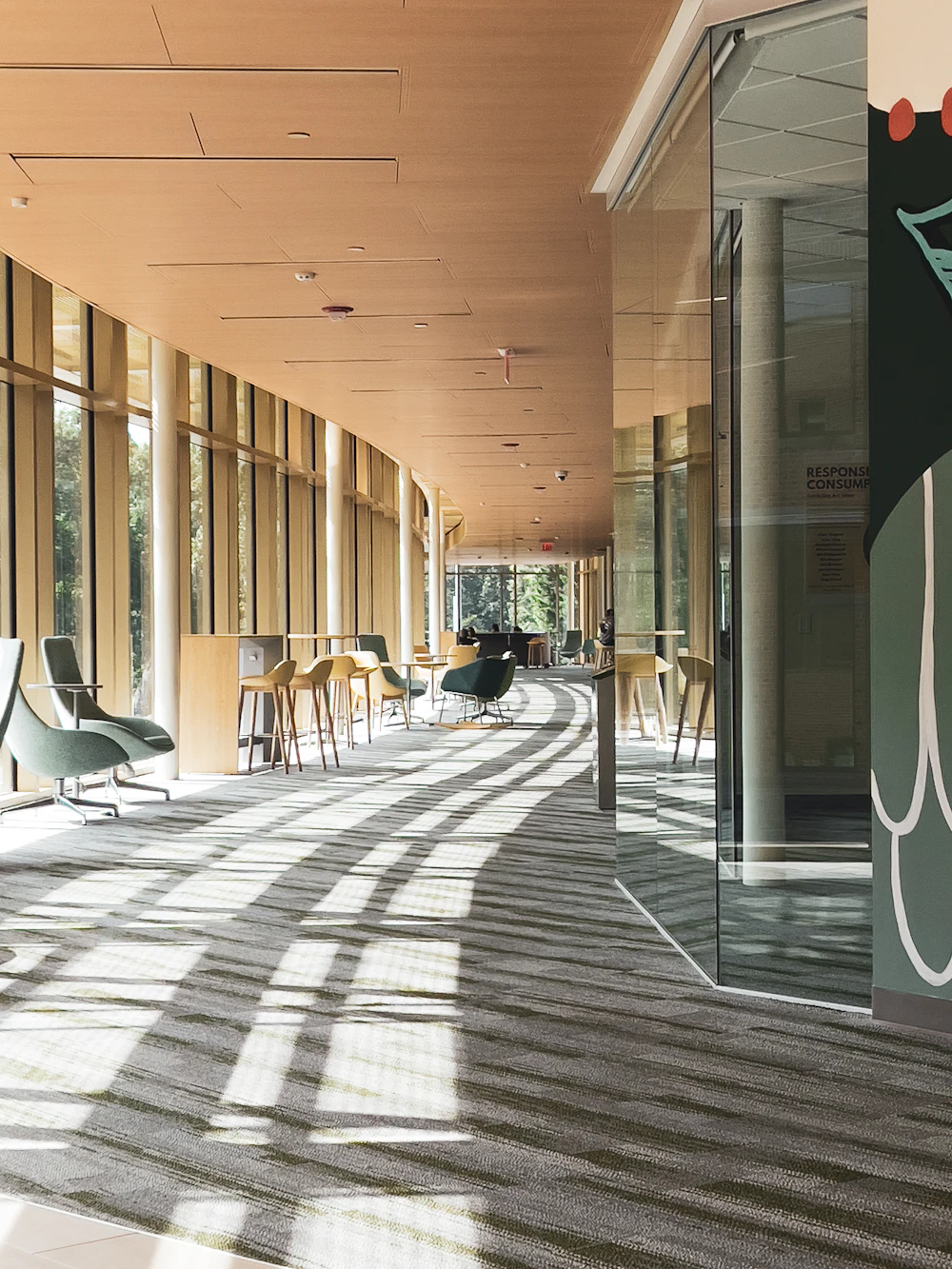 Long bright corridor with seating and large windows