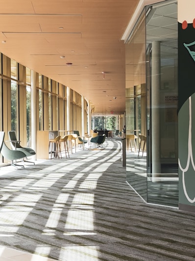 a long hallway with chairs and tables in it
