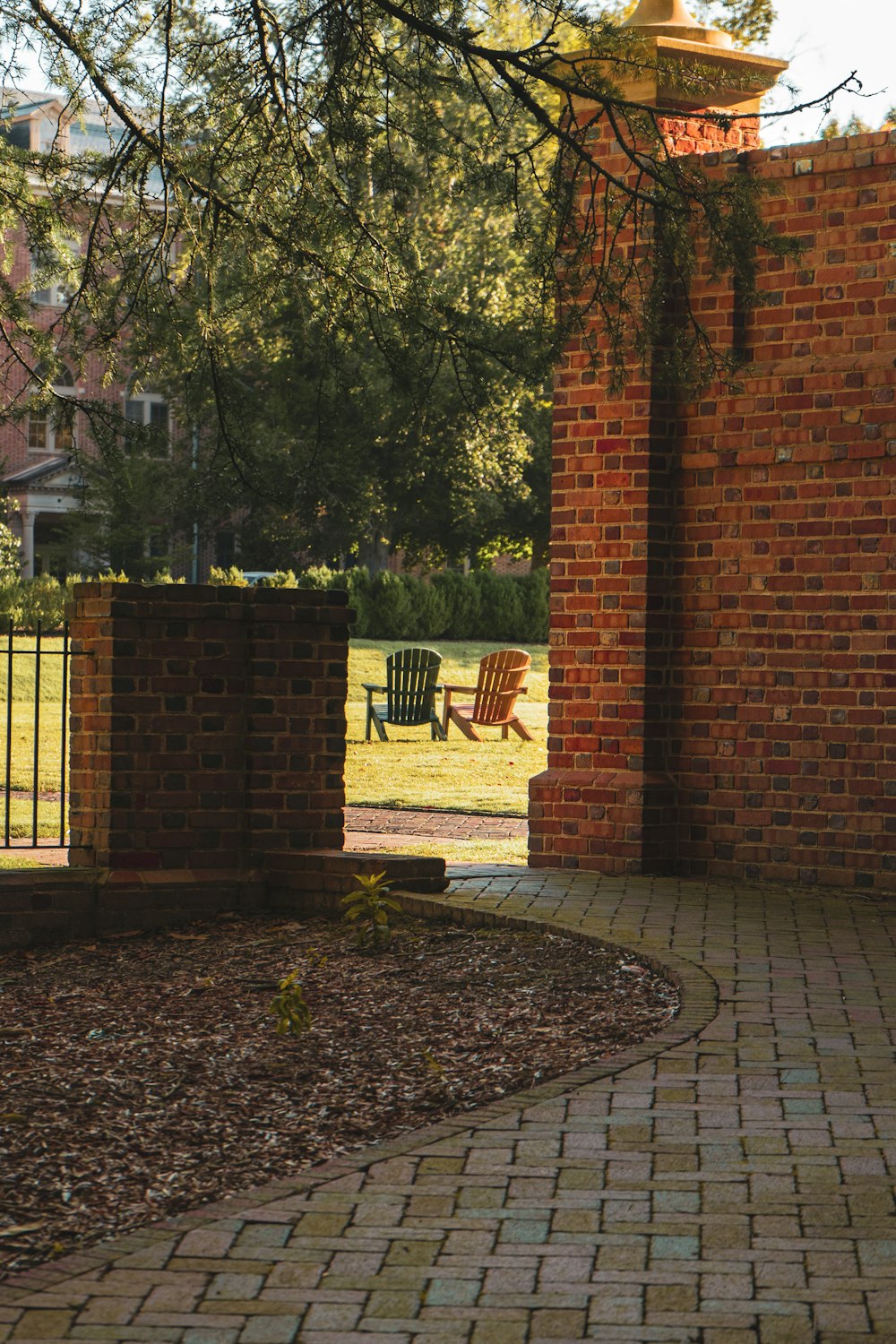 a brick walkway with a chair in the background