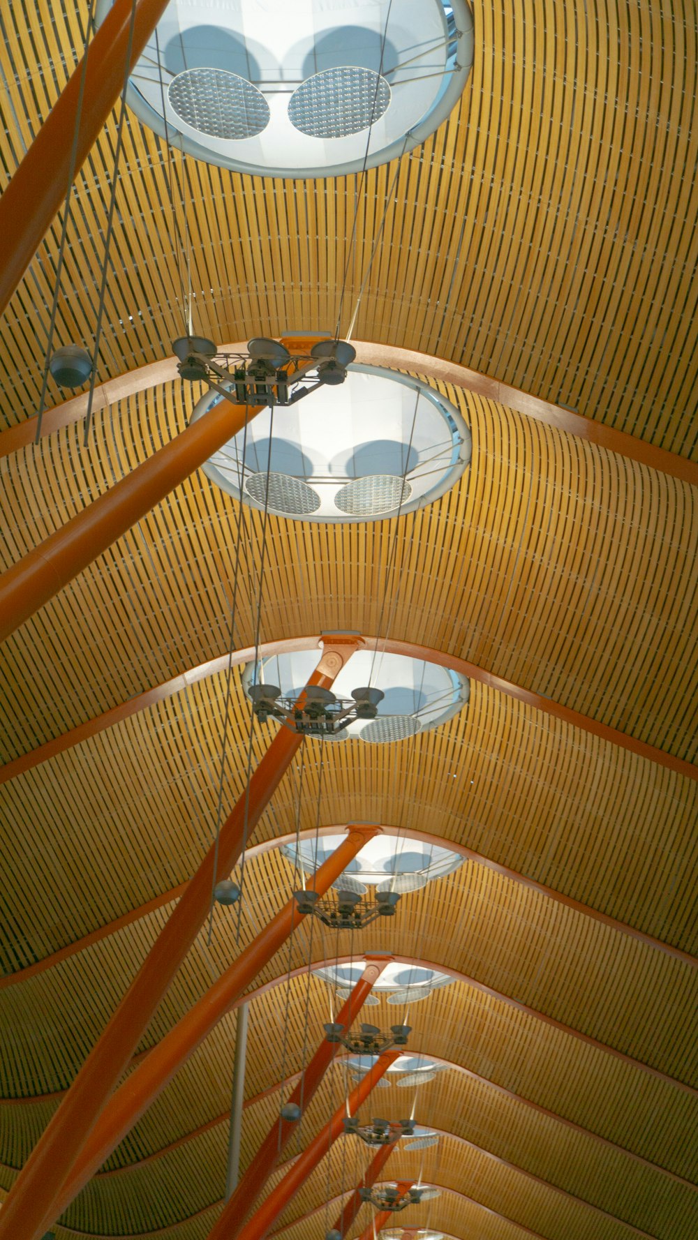 the ceiling of a building with many circular lights