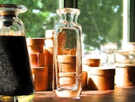 Bright sunlight shining through a window onto bottles of natural supplements.
