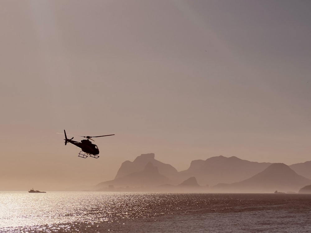 a helicopter flying over a body of water