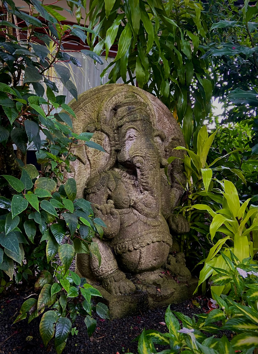 a statue of an elephant in a garden