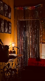 Vintage photo booth with warm glowing lights in a dark, stylish setting.