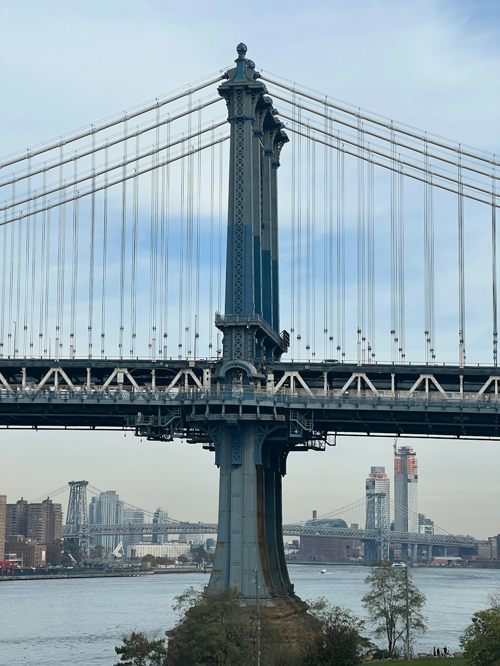 a tall bridge with a clock on the top of it