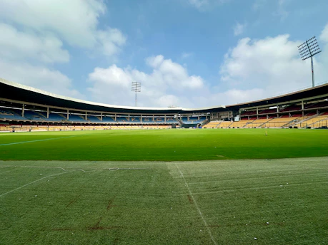 an empty soccer field with a sky background
