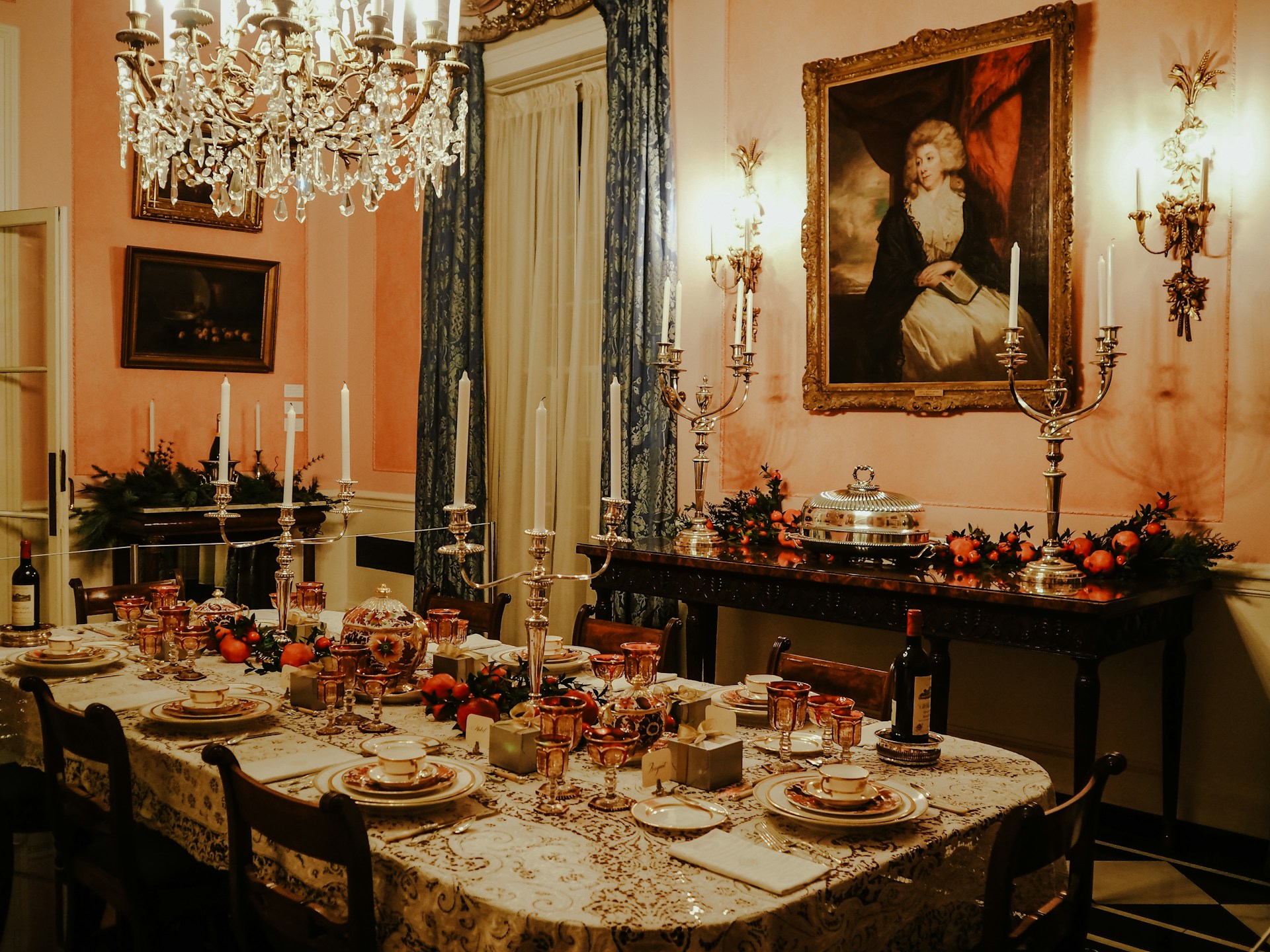 An exquisite banquet table set for a formal dinner, adorned with fine china and candles.