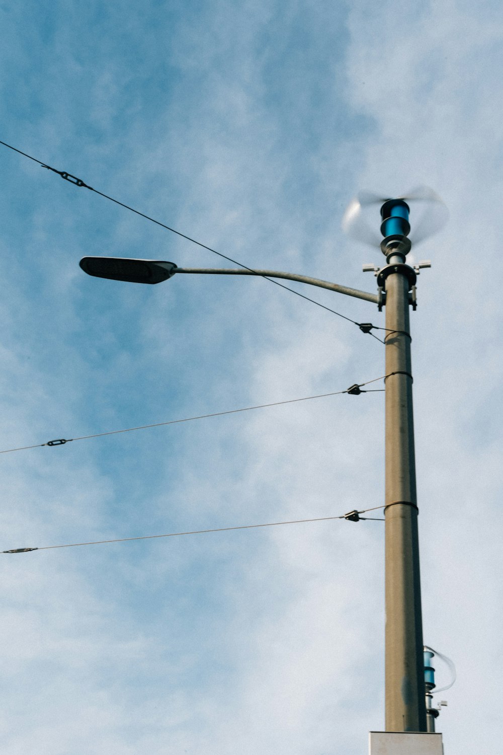 a street light on a pole with a blue sky in the background