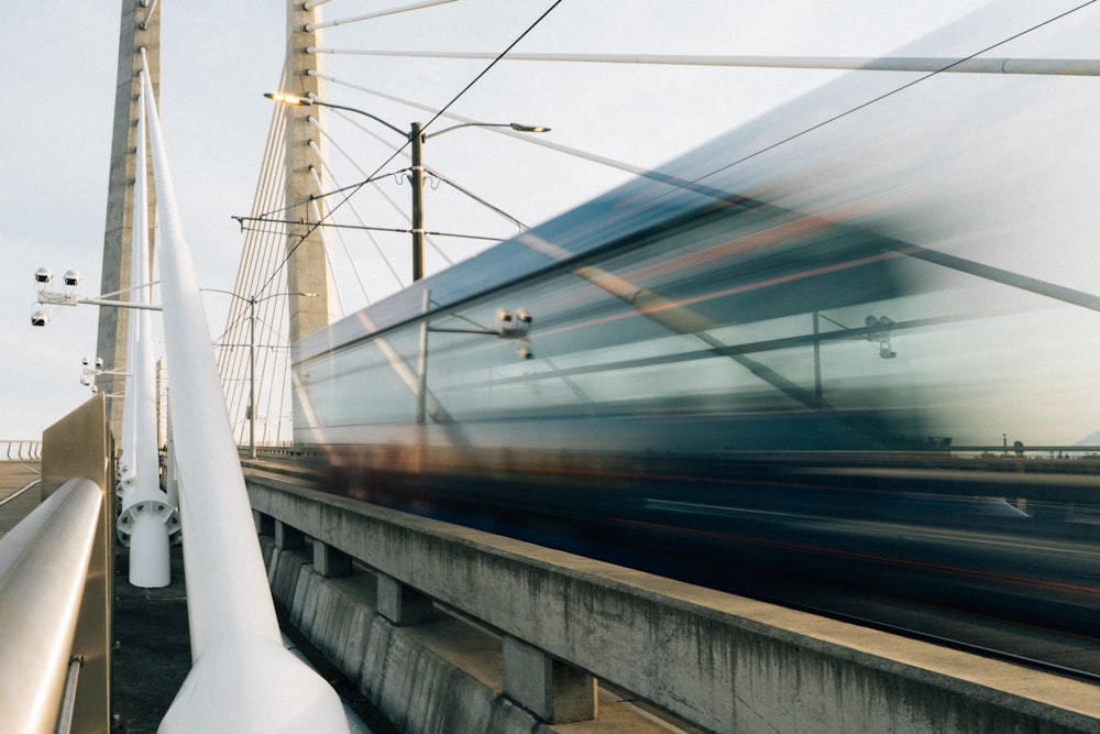 a blurry photo of a train going over a bridge