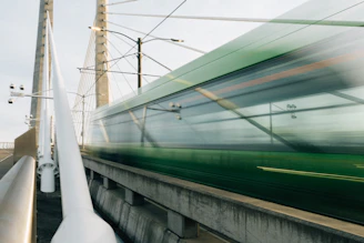 A modern train crossing a bridge symbolizing Franco-Moroccan railway collaboration.