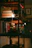 Close-up of a beautifully assembled book nook glowing with warm lights on a cozy wooden shelf.