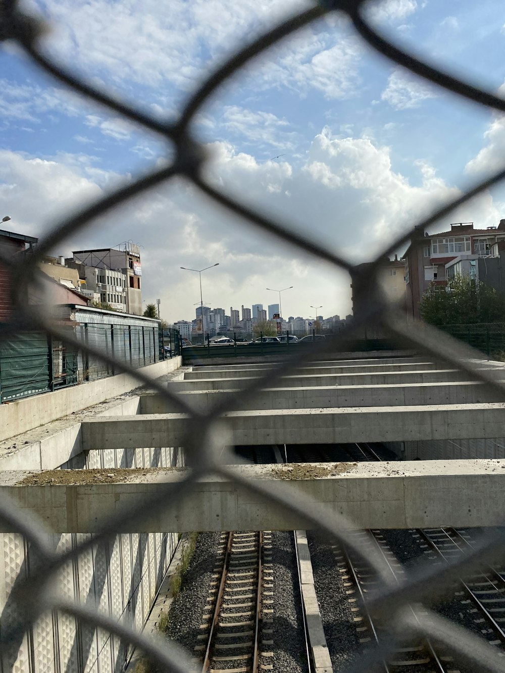 a view of a train track through a fence