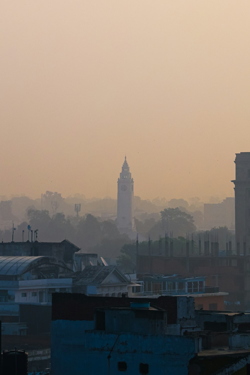 a city skyline with a clock tower in the distance