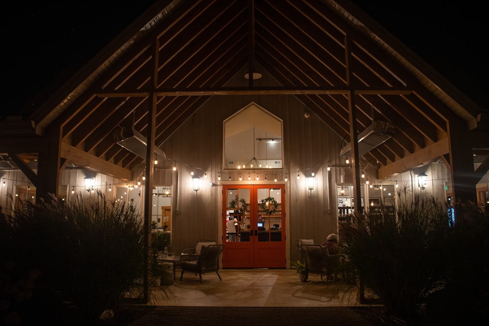 a lit up building with a red door at night