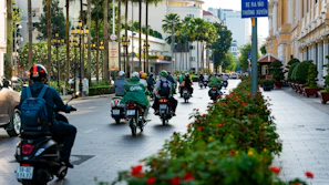 a group of people riding motorcycles down a street