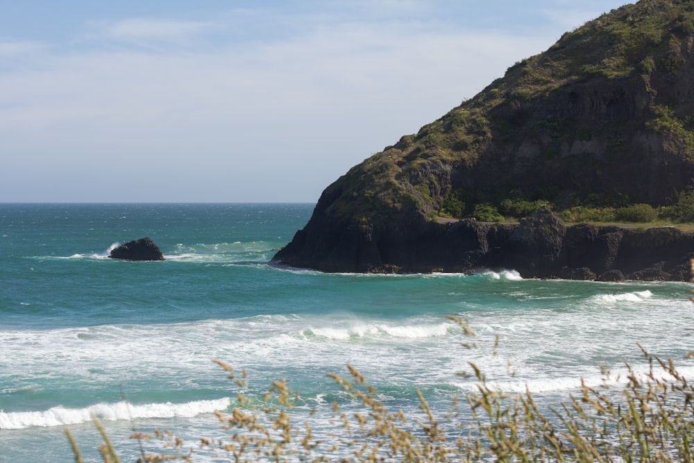 a large rock sticking out of the ocean