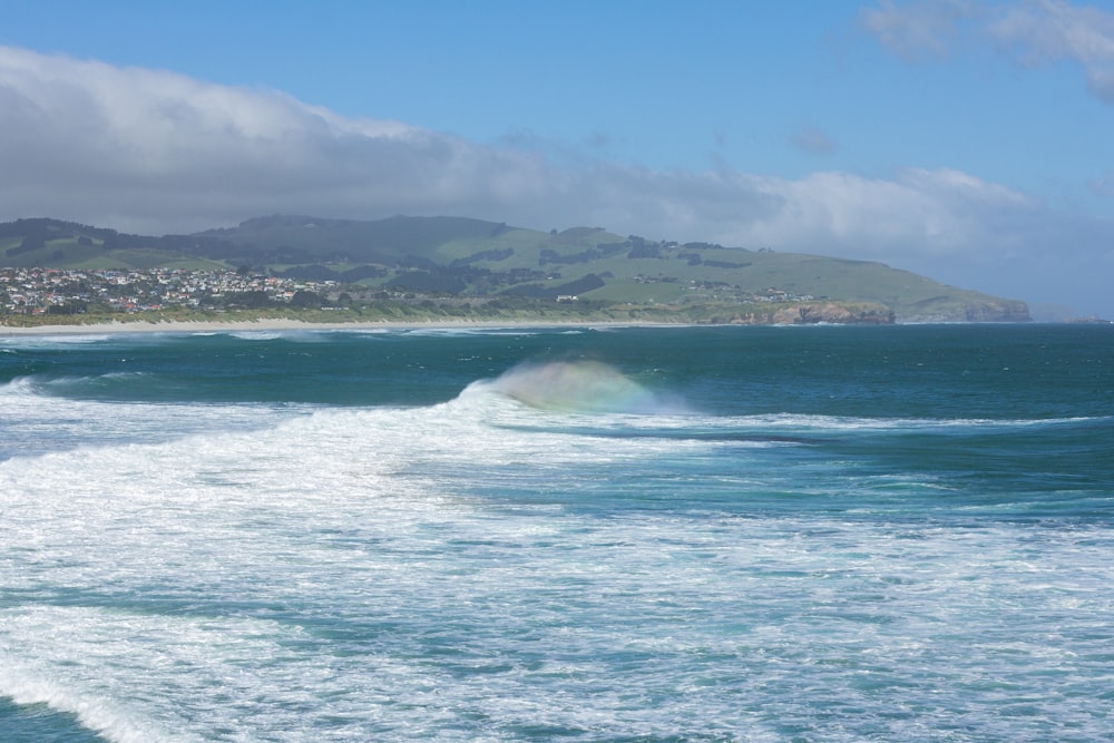 a person riding a wave on top of a surfboard