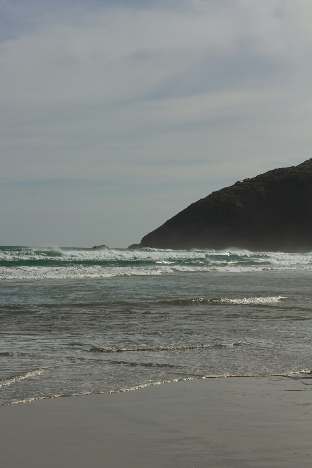 a beach with waves coming in to shore