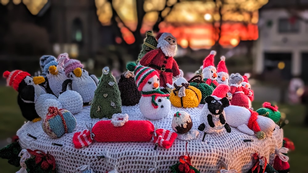 a group of knitted snowmen sitting on top of a table