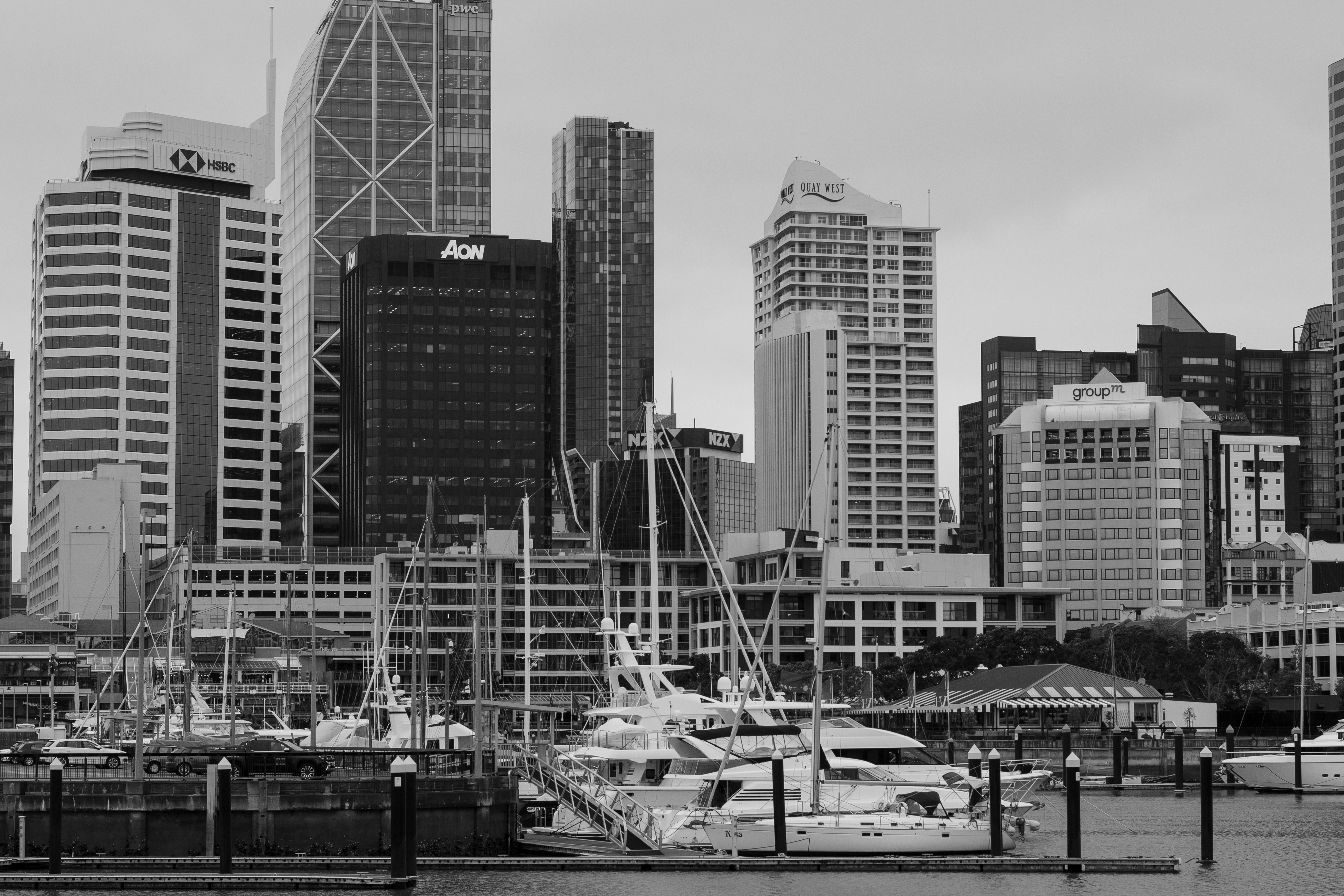 a black and white photo of boats docked in a harbor, Viaduct Harbour, Auckland
