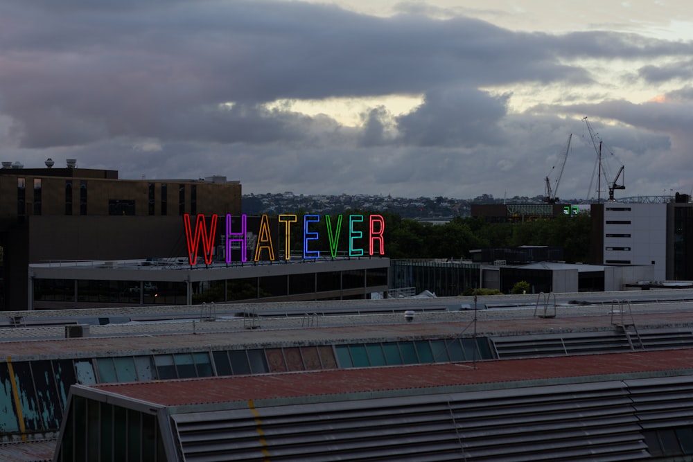 a sign that says whatever on top of a building