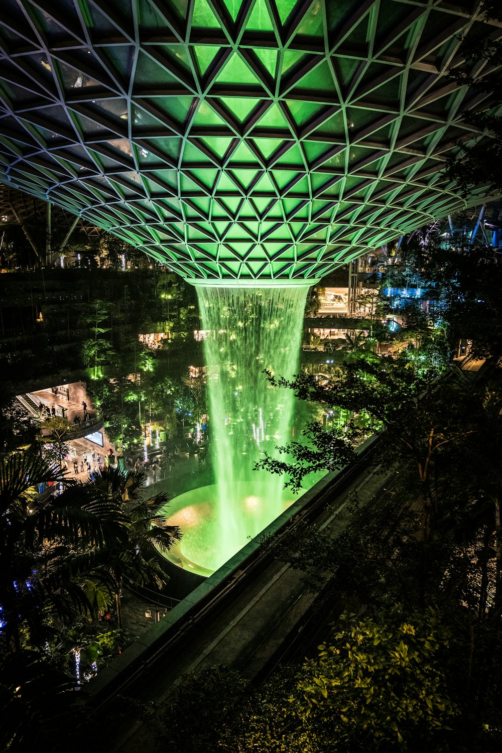 a view of a fountain in a city at night