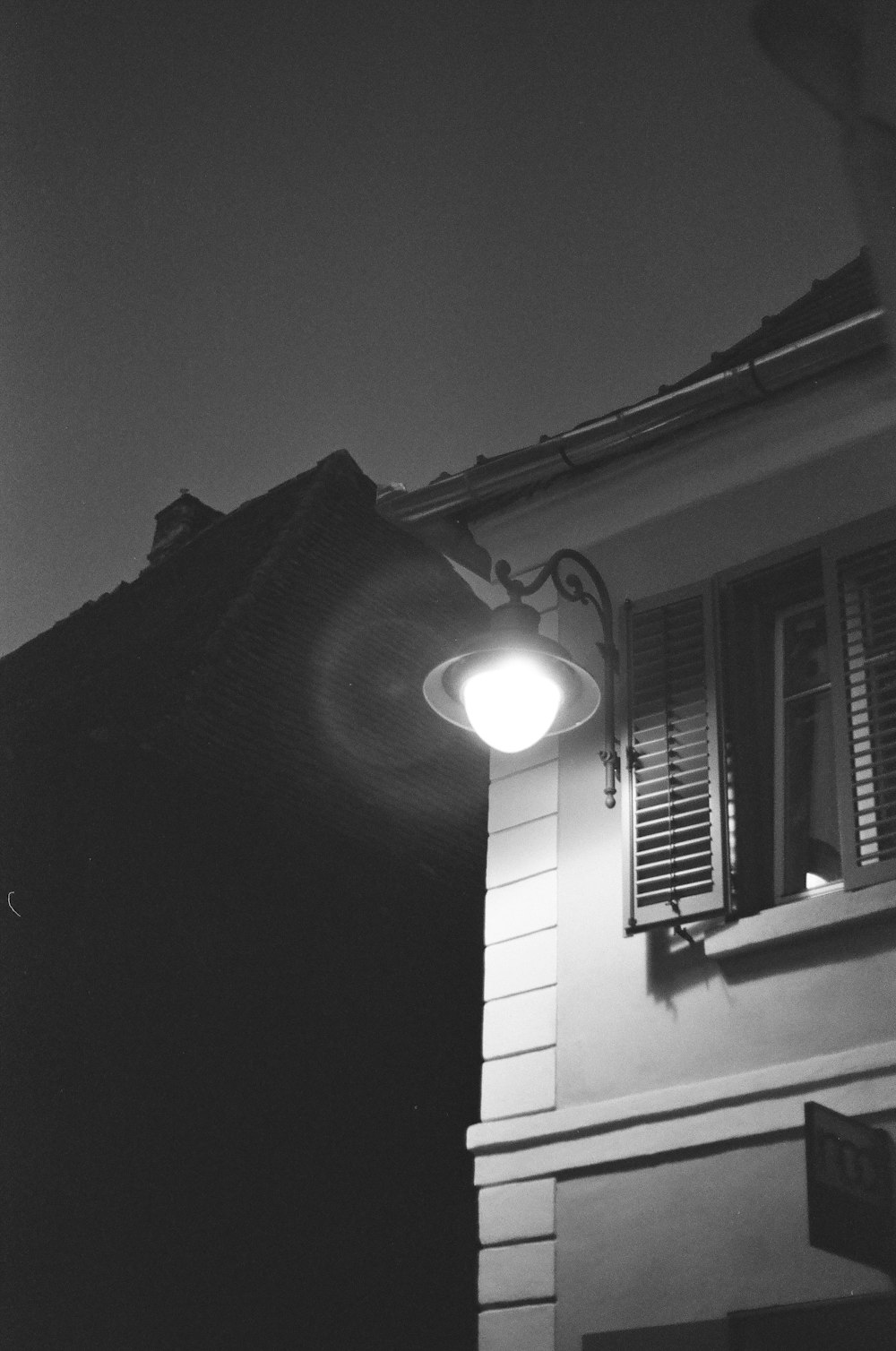 a black and white photo of a street light