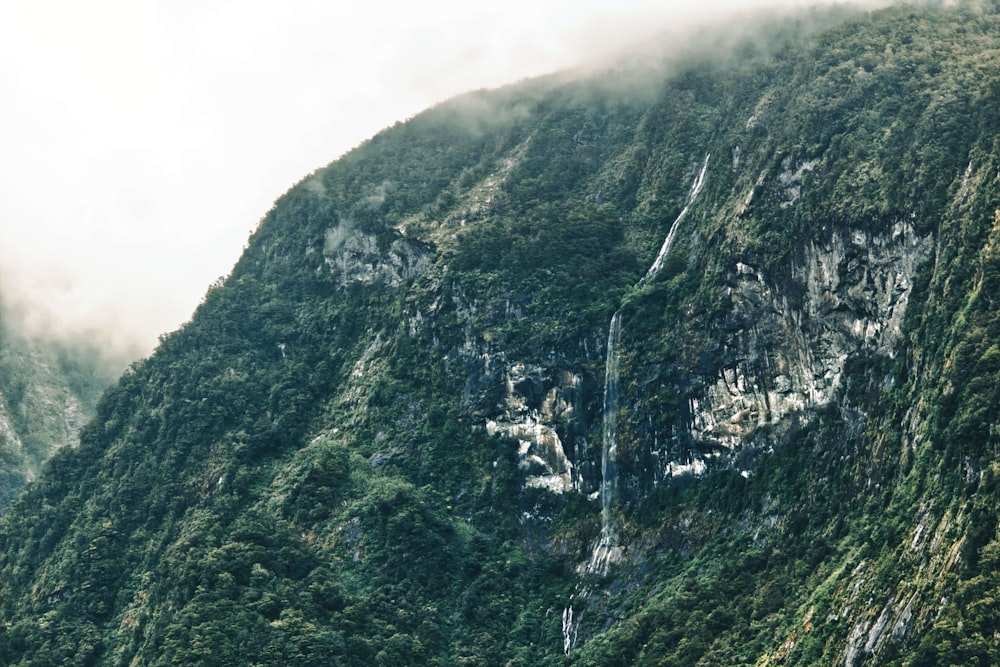 a very tall mountain with a waterfall in the middle of it