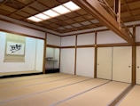 An instructor explaining Japanese culture with visual aids in a minimalist, elegant room.