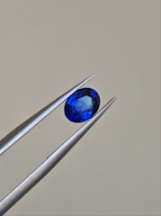 Technician using advanced equipment to test gemstone properties.