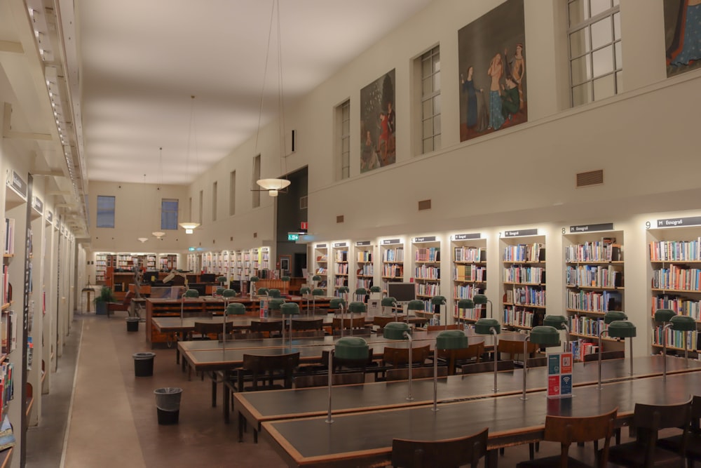 a library filled with lots of tables and chairs