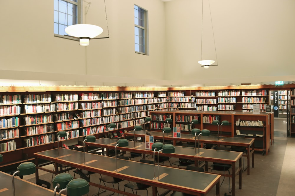 a library filled with lots of tables and chairs