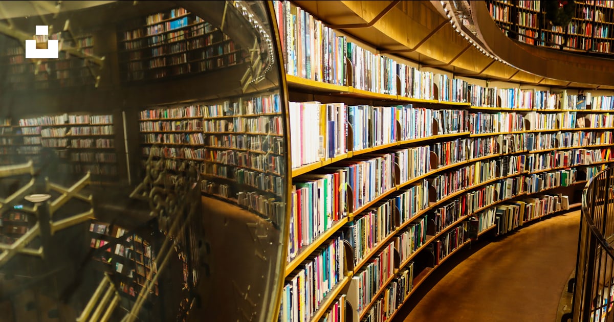 A large library filled with lots of books photo – Free Library Image on ...