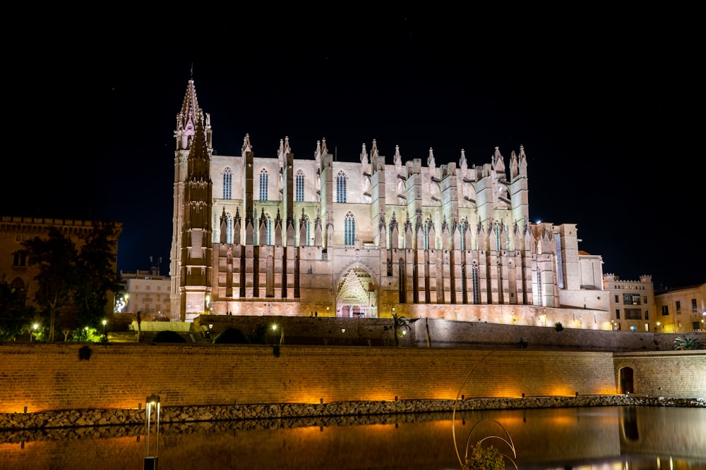 a large cathedral lit up at night with lights on