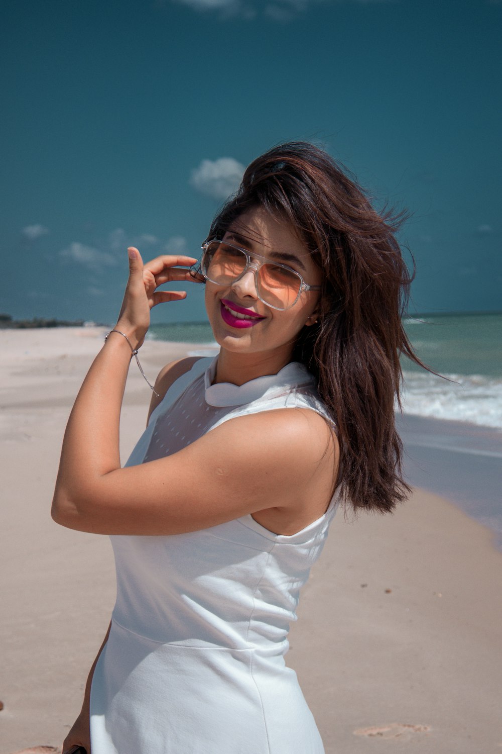 a woman in a white dress on the beach