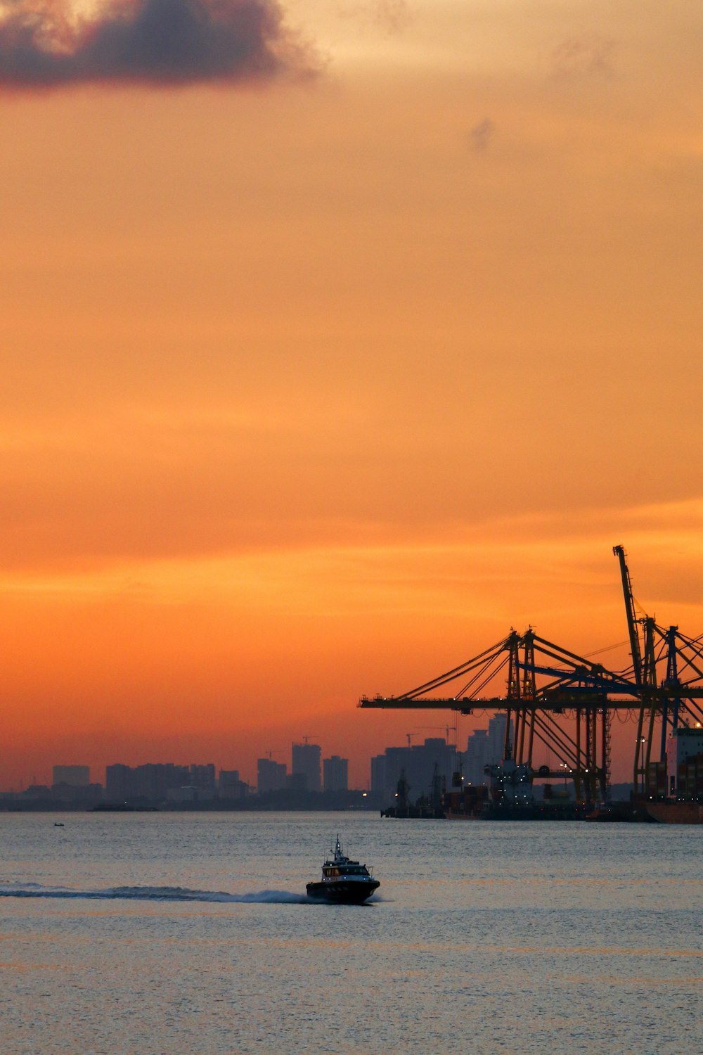 a boat in the water with a city in the background