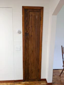 Close-up of the room door with a warm wooden finish.