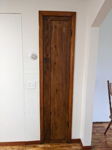 Smooth wooden door with natural varnish in a cozy room