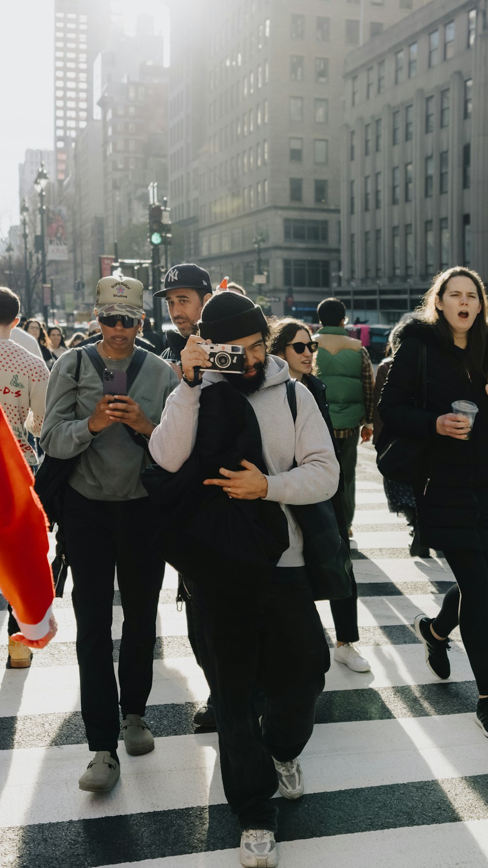 a group of people walking across a cross walk