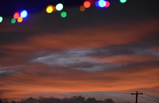 A striking photo of community members collaborating under a vibrant orange sky, symbolizing energy and hope.