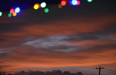 A striking photo of community members collaborating under a vibrant orange sky, symbolizing energy and hope.