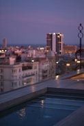 Luxurious rooftop pool overlooking Dubai’s skyline at dusk.
