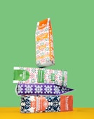 An array of colorful coffee bags branded with Happy Mug Roasters logos arranged neatly.