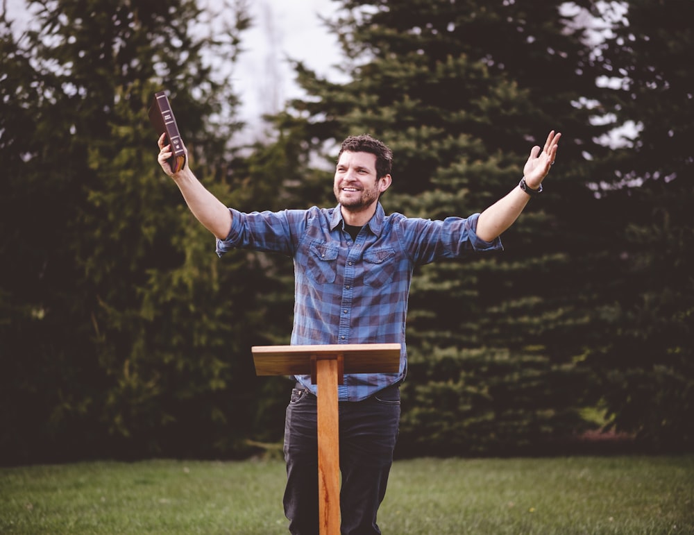 a man holding a cell phone up in the air