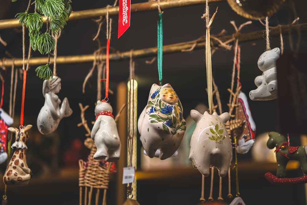 a group of ceramic animals hanging from strings