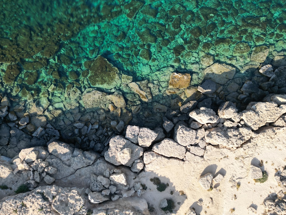 an aerial view of the water and rocks