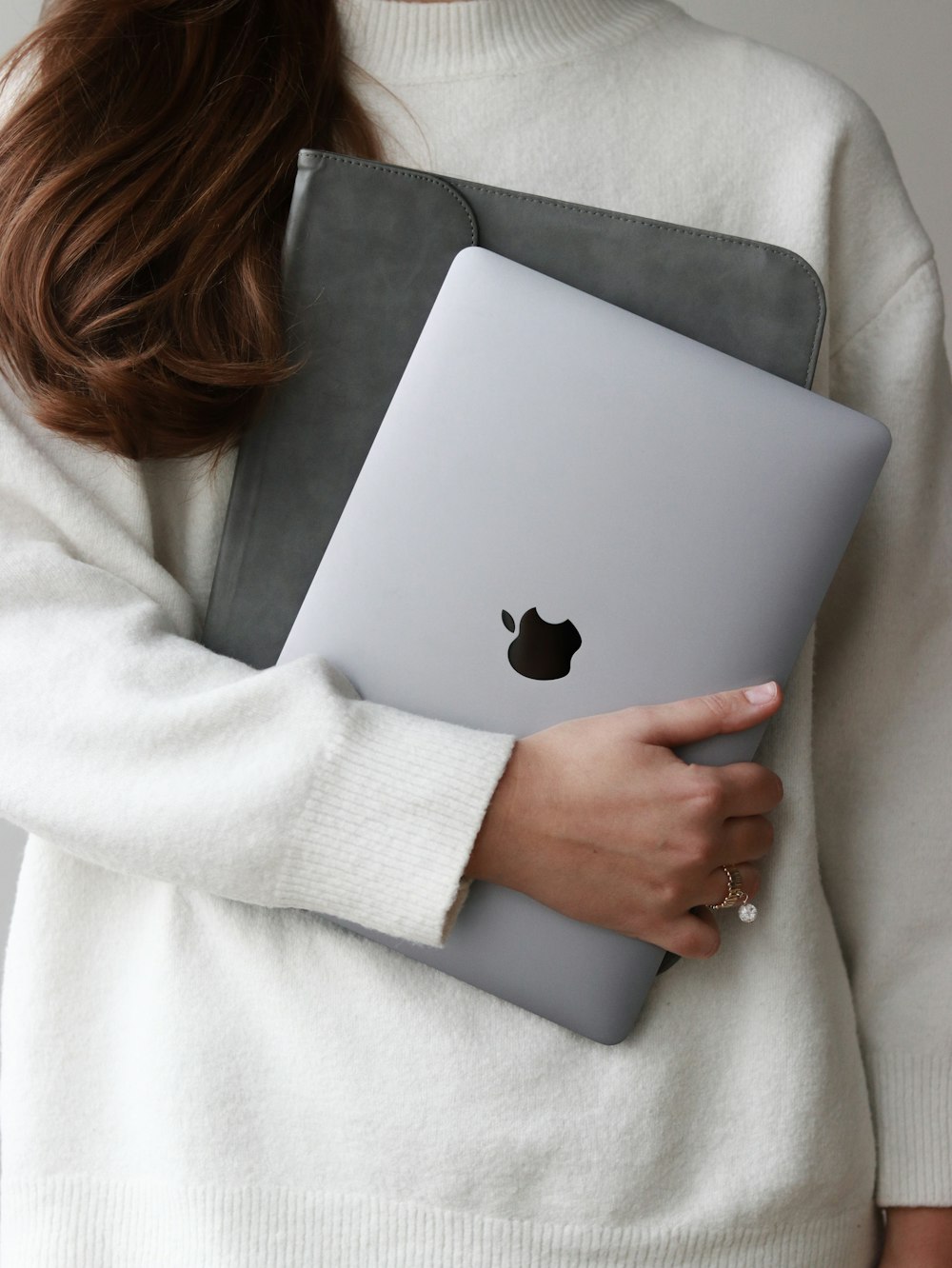 a woman holding a laptop computer in her hands