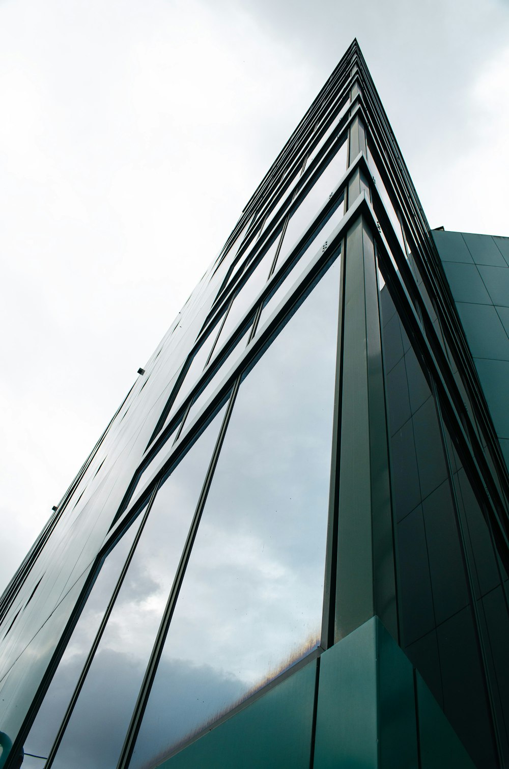 a tall glass building with a sky background