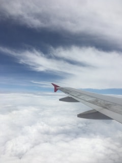 the wing of an airplane flying above the clouds