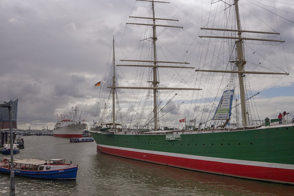 a large green and red boat in a body of water